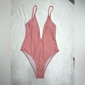 Light pink one-piece swimsuit. Sz Large. Comprised of 80% nylon and 20% spandex.